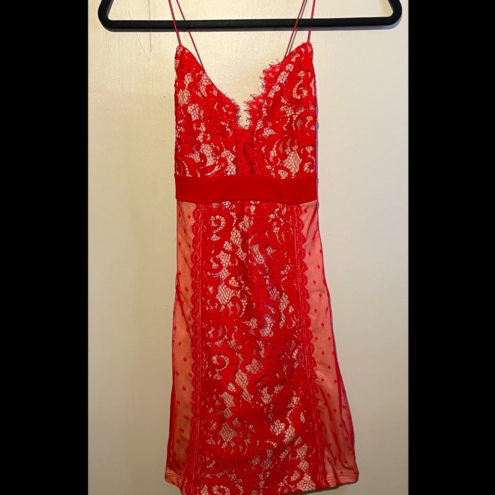 Never been worn.Sexy spaghetti strap dress. Red lace with nude slip underneath.